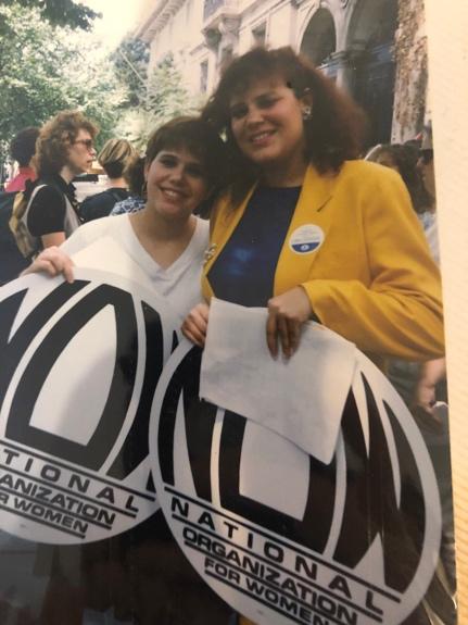 A group of women holding signs

Description automatically generated